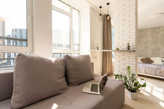 laptop is on the couch in modern minimalist design of bright living room