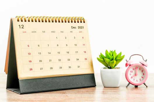 The December 2021 desk calendar on wooden table.