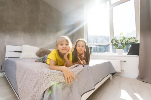 Creative cute girls, two sisters at home