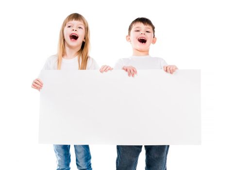 little cute boy and girl holding an empty paper sheet isolated on white background