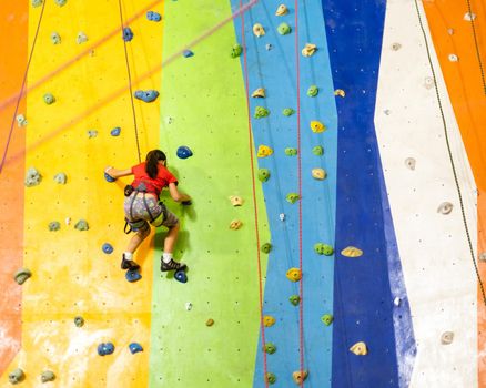 Little Girl Climbing Rock Wall