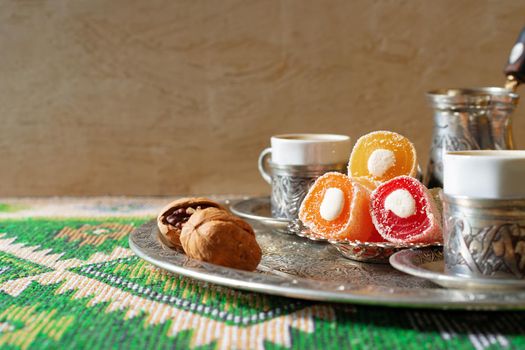 Turkish Coffee served with Turkish Delight on metal tray, close up