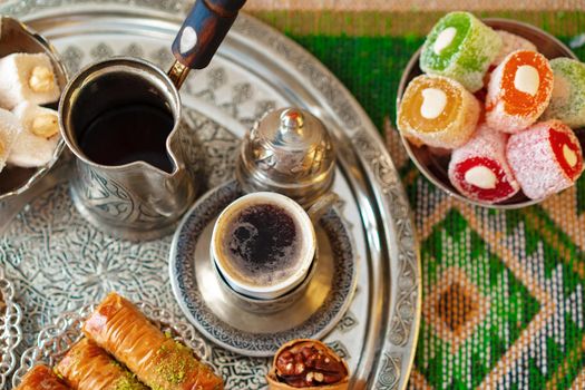 Turkish Coffee served with Turkish Delight on metal tray, close up