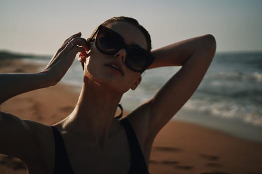 Cheerful woman black swimsuit ocean nature summer tan. High quality photo