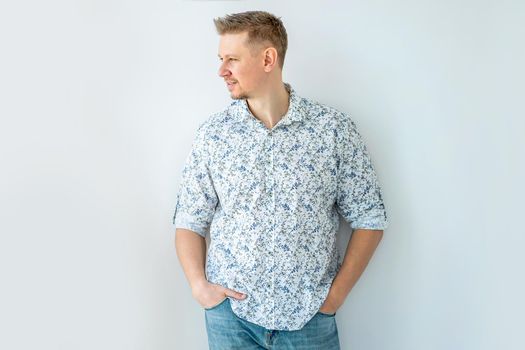 Handsome man wearing cute shirt looking aside