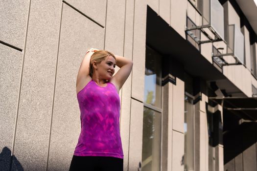 Fitness sport woman in fashion sportswear doing yoga fitness exercise in the street, outdoor sports, urban style