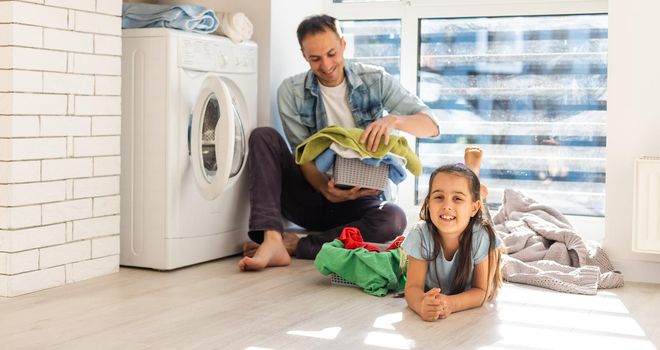 happy casual multiethnic family laundry clothes at home