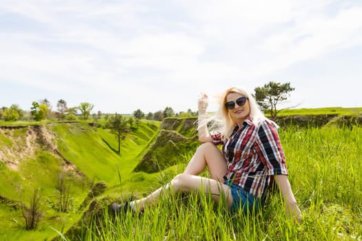 Attractive young woman enjoying her time outside in park, summer