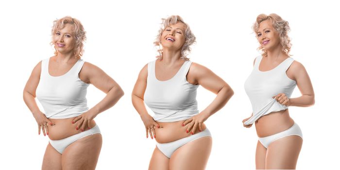 Smiling slimming middle aged model in white lingerie. Process of slimming. Isolated on white background.