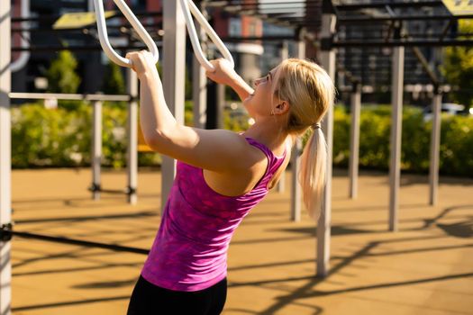 woman working out in gym on equipment outdoors having fun