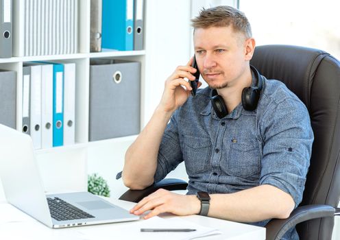 Smiling man working in light office