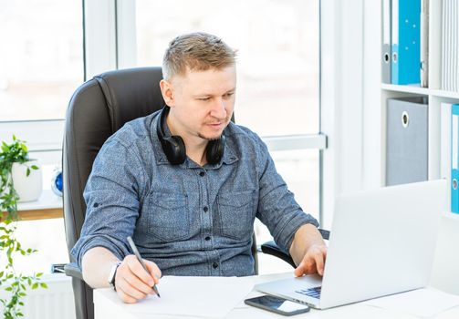 Smiling man working in light office