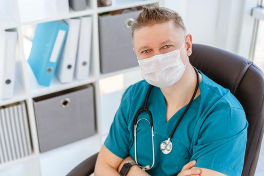 Doctor in protective mask at workplace