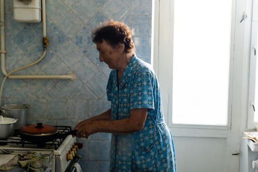 Happy senior woman cooking at home