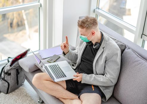 Man working distantly on computer during coronavirus pandemic
