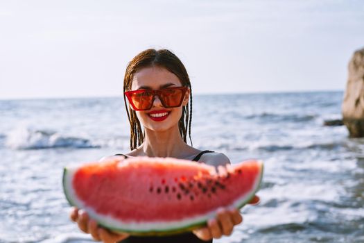 cheerful pretty woman in black swimsuit watermelon fashion travel. High quality photo
