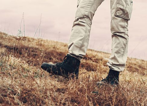 Man walking on nature in spring, view of legs