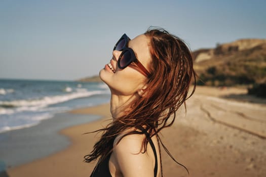 cheerful woman sunglasses posing black swimsuit island. High quality photo