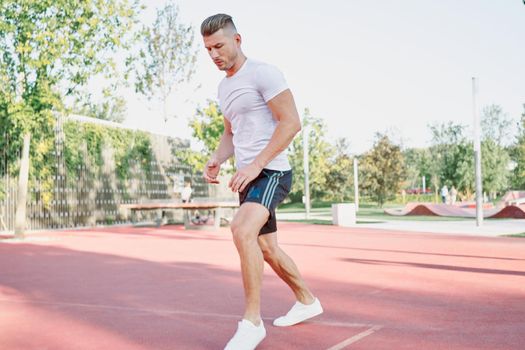 man doing exercises outdoors on the playground. High quality photo