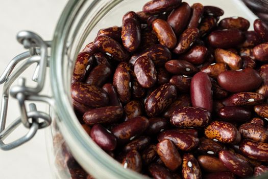 Raw cereals or beans in glass jars close up. Vegan and vegetarian food. Close up.