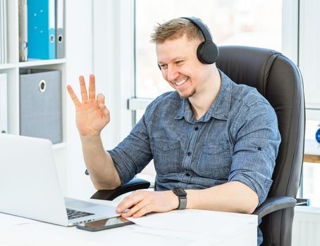 Handsome businessman chatting by video conferencing