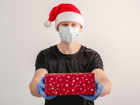 A courier delivers a parcel on Christmas Day during the coronavirus pandemic. On white background