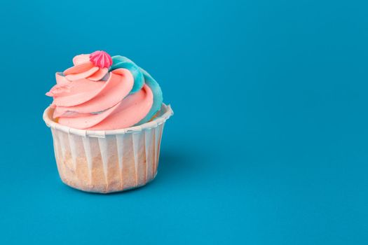 Birthday cupcakes on blue background close up