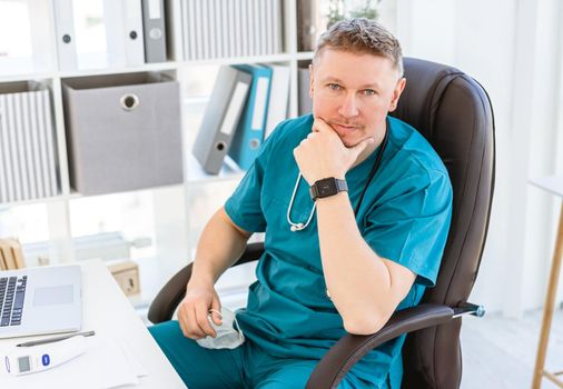 Smiling doctor wearing uniform in light office