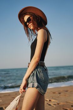 woman in trendy summer clothes by the ocean vacation sun. High quality photo