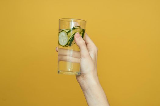 cucumber Fresh vitamins detoxification yellow background. High quality photo