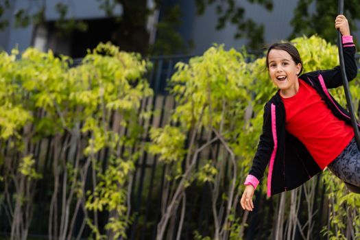 The little girl on the bungee jumping for kids outdoor.