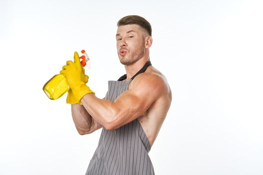 cheerful man in apron detergent posing muscles. High quality photo