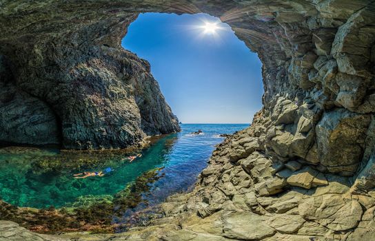 girl dive in the Diana's grotto Sevastopol. Fiolent, Crimea on a background of rocky shores. The concept of an travel, relax, active and healthy life in harmony with nature