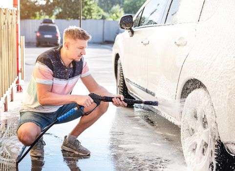 Man washing car at self service car wash