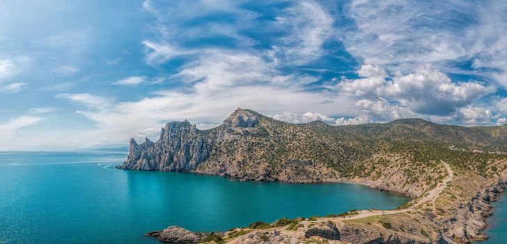 Beautiful seascape, panorama of cape Kapchik to the Galitsin Trail and blue bay of the Black Sea. Sudak, New World. Landscape of the sea coast. The concept of calmness, silence and unity with nature