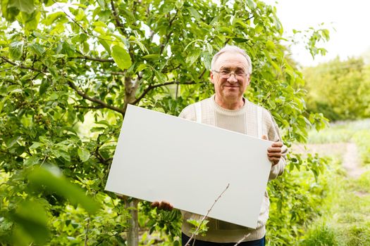 elderly man holding a photo canvas