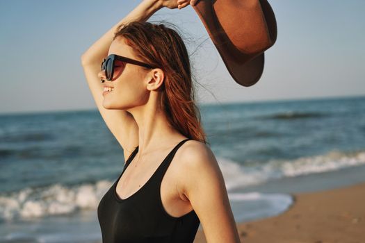 woman in a hat sunglasses by the ocean travel sun. High quality photo