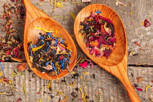Handful of natural tea on a wodden surface