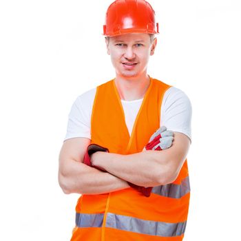 handsome worker man in a helmet folded his arms on a white background isolated