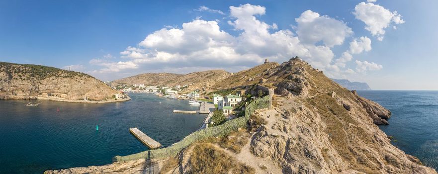 Scenic panoramic view of Balaclava bay with yachts from the ruines of Genoese fortress Chembalo. Balaklava, Sevastopol, Crimea. Inspirational travel landscape. Aerial photo. Copy space
