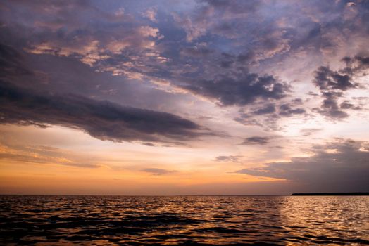 orange sunset over the sea with clouds in the sky