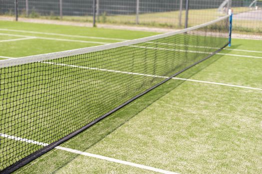 Tennis net and court. Playing Tennis. Healthy lifestyle