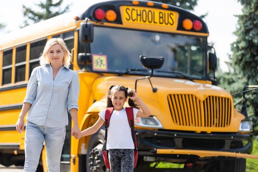 Mother taking her daughter to school, saying her goodbye for the day