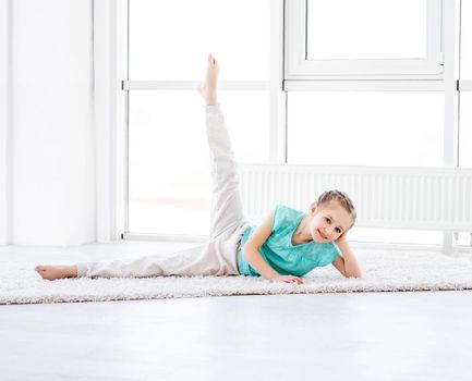 Cute little girl doing workout in gym