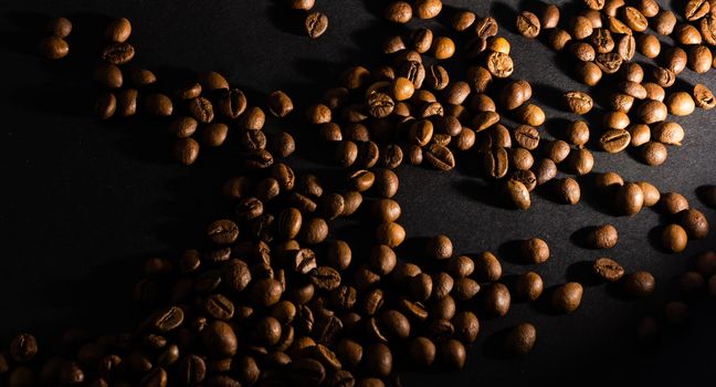 Flying coffee beans over dark.