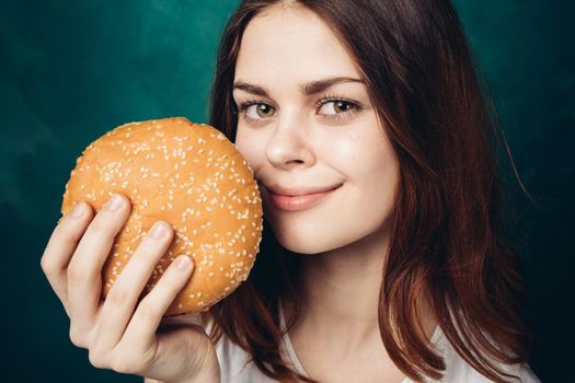 woman eating hamburger fast food snack close-up. High quality photo