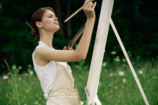 woman outdoors paint a picture landscape hobby creative. High quality photo