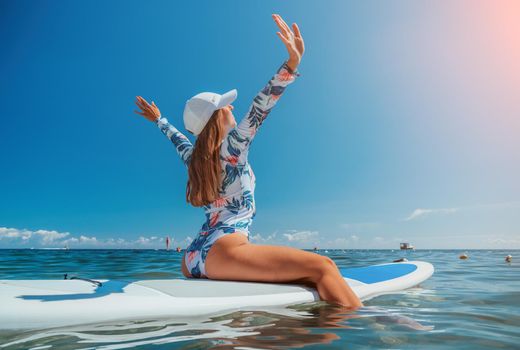 SUP Stand up paddle board. Young woman sailing on beautiful calm sea with crystal clear water. The concept of an summer holidays vacation travel, relax, active and healthy life in harmony with nature