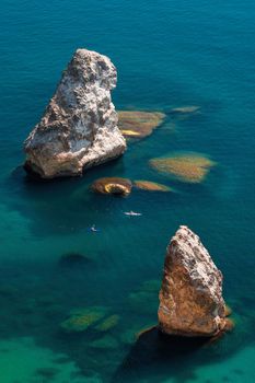 Two Kayaks on the background of coastal cliffs, calm clear blue sea, rock Orest and Pilad cape Fiolent in Balaklava Sevastopol Crimea. The concept of an active and healthy life in harmony with nature