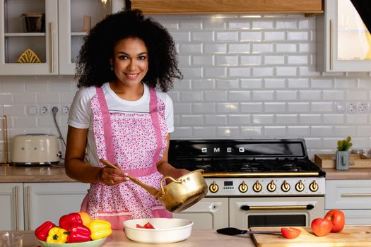 Young woman cooking vegetables in the kitchen. High quality photo.